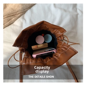 Internal view of the caramel bucket bag showing storage space for phone and makeup