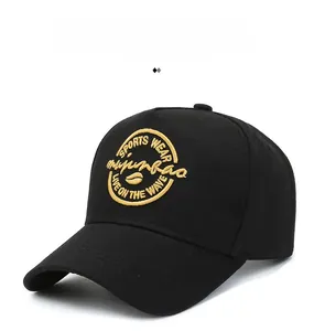 Close-up of golden sports embroidery on a black cotton baseball cap with twill texture