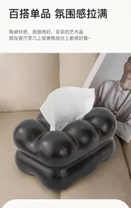 Detail der kreativen wolkenförmigen schwarzen Keramik Taschentuchbox auf Sofa