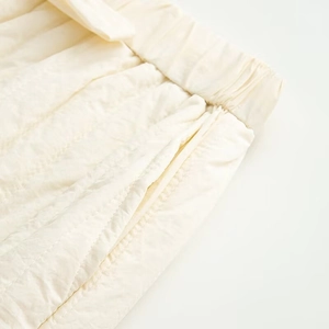 Detail of elastic drawstring waist and side seam pockets on cream casual cotton set