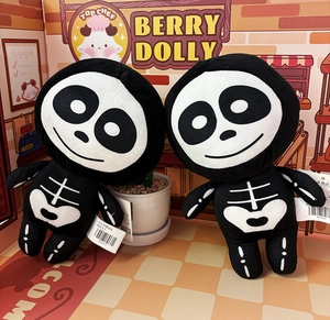 Close-up of 8-inch plush skeleton dolls with cute embroidery and original tags