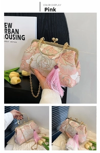 Detailed shot of pink floral embroidery shell bag with gold clasp and tassel detail
