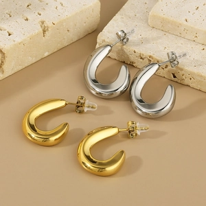 Detailed shot of hollow oval C-shape hoop earrings in polished gold and silver finishes