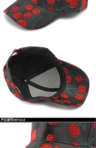 Detail view of red cherry embroidery on black baseball cap with interior sweatband