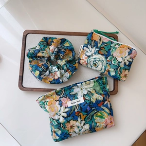 Detailed set of floral cotton pouches and scrunchie with blue and green oil painting prints