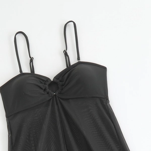 Detail view of black bikini top with metal ring buckle and translucent mesh hem decoration