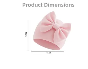 Detail view of pink infant beanie showing 15cm width and 13cm height with big bow