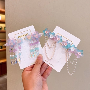 Detail of purple and blue floral Hanfu hair clip with faux pearl fringe on display card