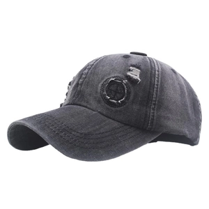 Vintage washed charcoal denim baseball cap with distressed holes and compass patch