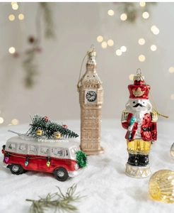 Detailed Christmas glass ornaments featuring a red bus, golden clock tower, and nutcracker