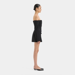 Side view of elegant black strapless blazer dress on female model in studio