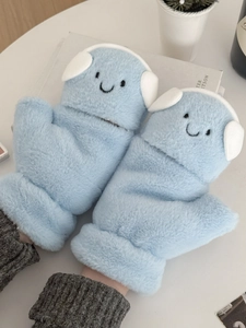 Detail of plush light blue flip-top gloves with cartoon smile and knit cuffs