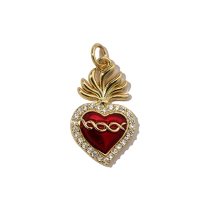 Detailed view of red enamel sacred heart pendant with gold filigree and cubic zirconia stones