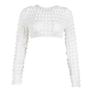 Macro detail of textured bubble fabric on a white long-sleeved cropped top for women