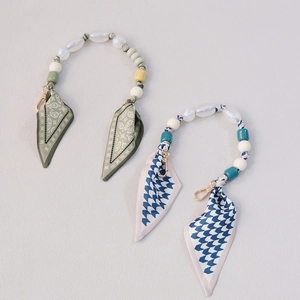 Detail of silk scarf bag straps with colorful beads and metal lobster clasps