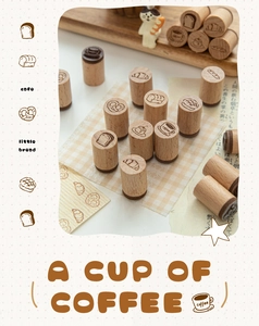 Artistic detail of wooden stamps with bakery and coffee motifs on a checkered tablecloth