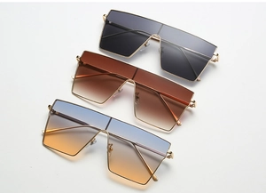 Flat lay of square metal sunglasses with colorful gradient lenses in multiple stylish colors