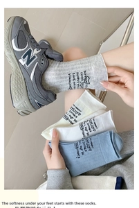 Close-up of ribbed cotton crew socks with heel letter print and heart logo detail