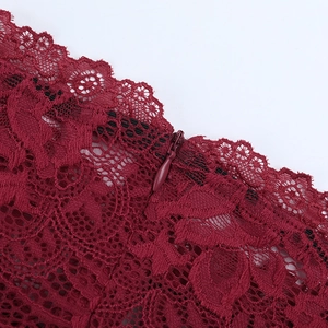Macro shot of wine red lace fabric detail with a seamless concealed zipper finish