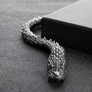Retro dragon stainless steel bracelet with detailed scales and green gemstone eyes