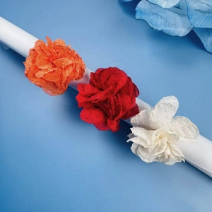 Elegant fabric flower rings in orange, red, and white for Christmas celebrations
