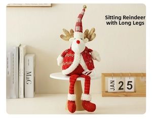 Detail of a Christmas plush elk ornament in a red knit sweater sitting on books
