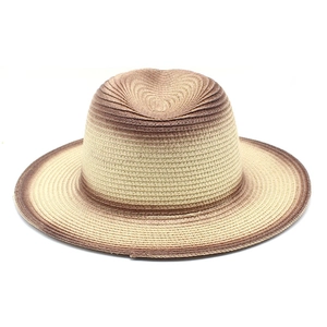 Detailed close-up of woven gradient straw sun hat showing texture and fedora style
