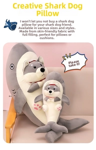 Detail of shark-dog plush pillow showing two sizes on a sofa with soft fabric texture