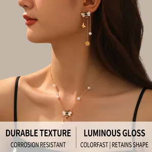 Detail of bee necklace with white pearls and flower tassel on an Asian female model