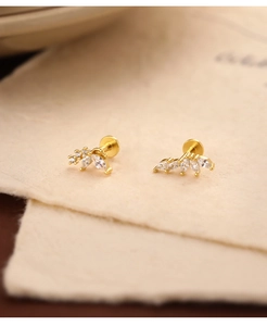 Macro view of gold s925 silver stud earrings with marquise and round zircon stones