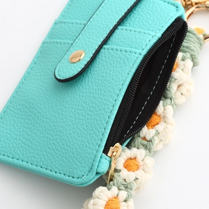 Mint green leather card holder with zipper pocket and hand-knitted daisy keychain