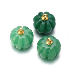 Macro shot of green aventurine pumpkin beads with golden metal loops for DIY jewelry