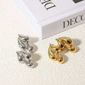 Minimalist gold and silver teardrop stud earrings with polished mirror finish surface