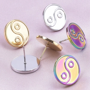 Detailed view of Tai Chi Yin Yang stud earrings in silver, gold and rainbow finishes