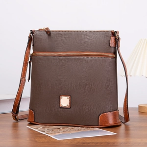 Close-up of retro pebbled texture leather crossbody bag with stitching details