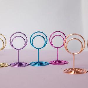 Colorful round metal wire card holders in various vibrant finishes for desk decor