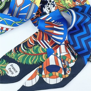 Detail of colorful ethnic silk scarf featuring France Paris text and intricate patterns
