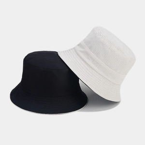 Detail of corduroy texture and stitching on reversible black and white bucket hats