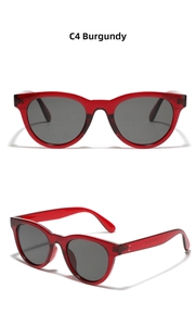 Detail view of retro round wine red sunglasses with dark polarized lenses and metal rivets