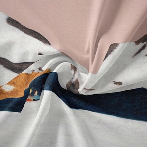 Macro detail of bohemian tapestry fabric showing soft texture and abstract art print