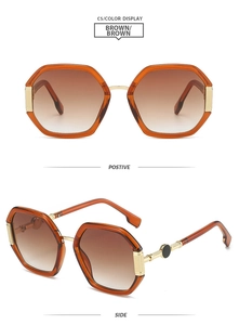 Detail of geometric brown sunglasses with gradient lenses and gold metallic temples