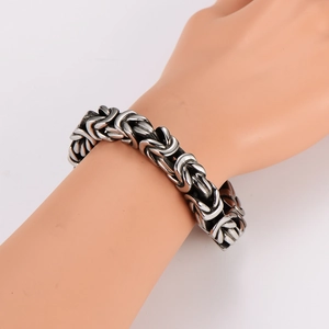Men's bold Byzantine woven stainless steel bracelet in retro steel color on a hand