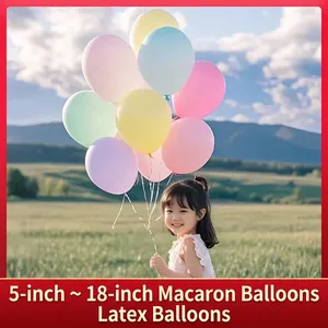 Colorful macaron latex balloons set for party decor held by a girl on green grass