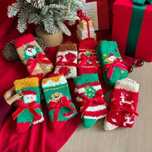 Macro detail of plush Christmas coral fleece socks set with festive holiday patterns