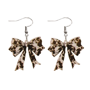 Detailed view of leopard print bow earrings with silver fishhook hooks on a white base