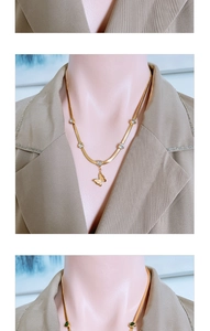 Close-up of golden snake chain necklace with heart rhinestones and matte butterfly pendant