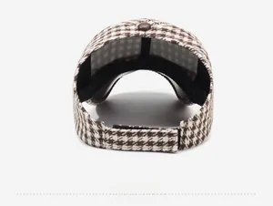 Detail view of the houndstooth baseball cap featuring an adjustable rear strap and buckle
