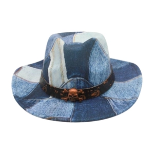 Detail of vintage denim patchwork fedora with bronze skull emblem on black band