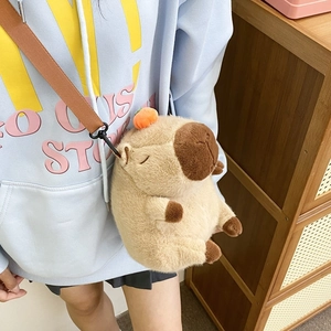 Detail of plush Capybara crossbody bag featuring soft faux fur and orange persimmon decor