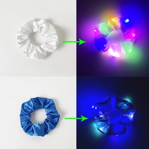 Detail of LED scrunchies in white and blue satin showing light-on and light-off effects